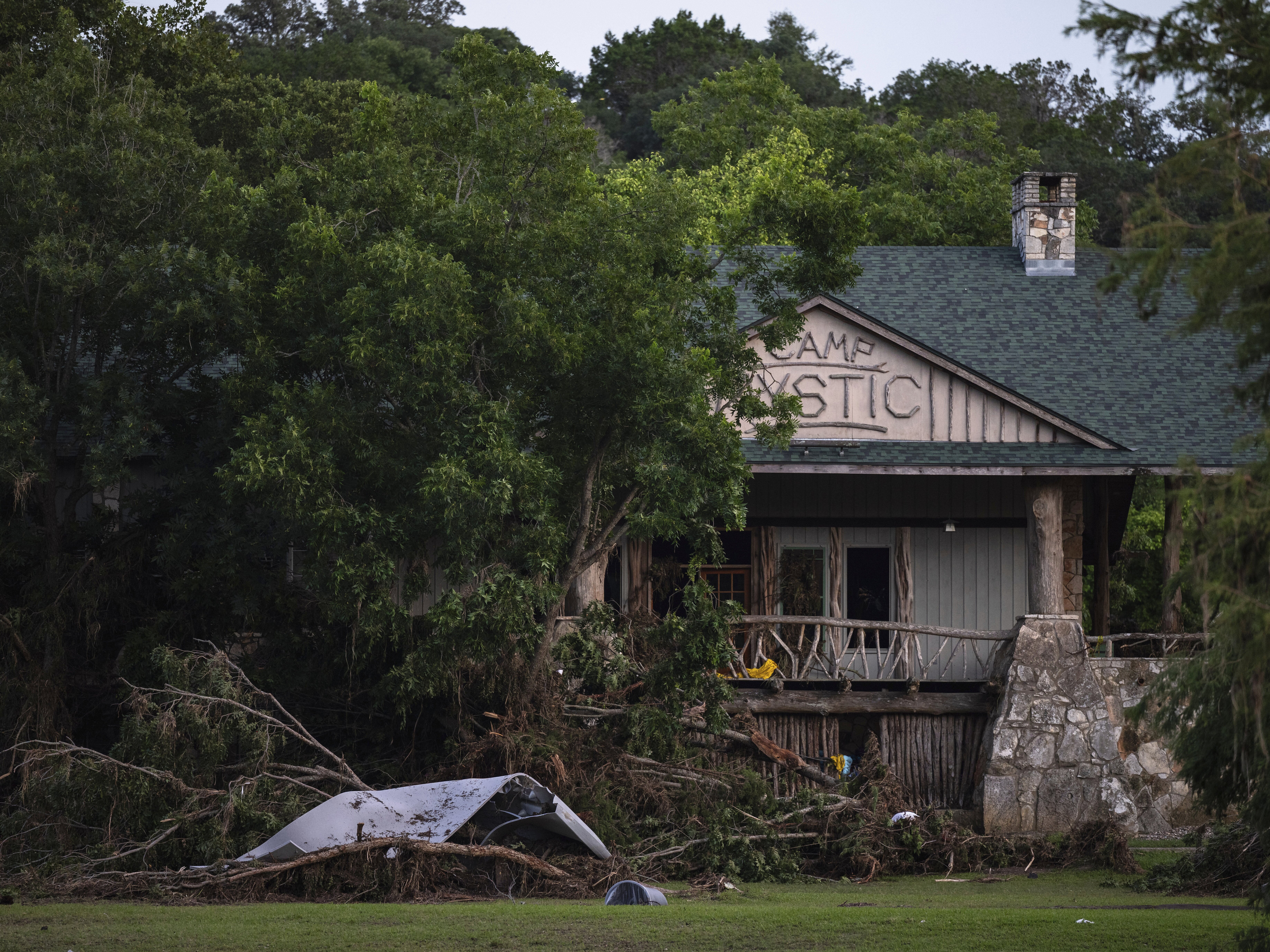 caption: Debris at Camp Mystic in Hunt, Texas, Monday, July 7, 2025, after a flash flood swept through the area.