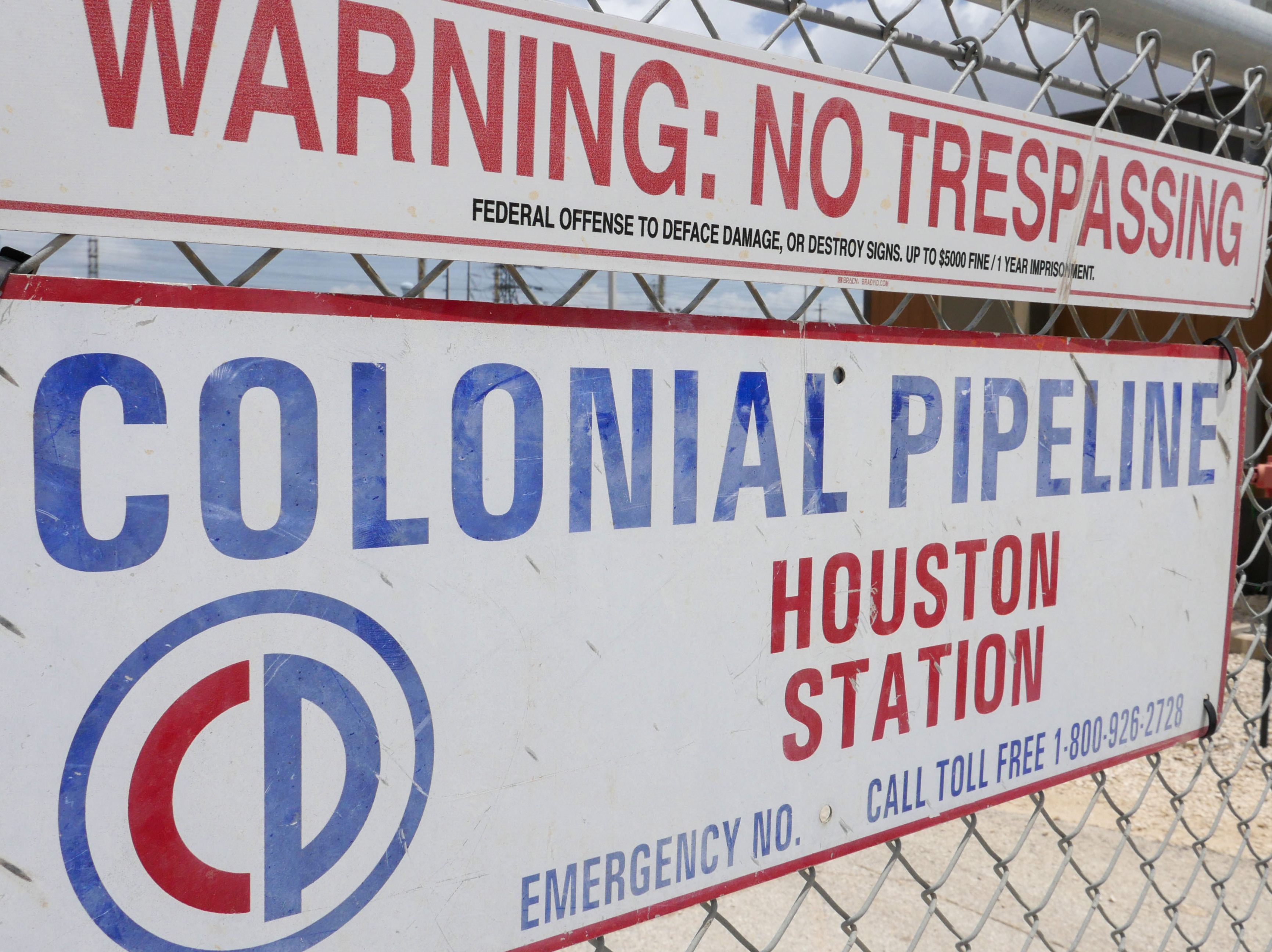 caption: A sign at the Colonial Pipeline Houston Station facility in Pasadena, Texas, warns against trespassing. Colonial was forced to shut down a key pipeline last month after suffering a ransomware attack. Such attacks are becoming more frequent and increasingly, they are targeting key infrastructure like fuel or food supplies.