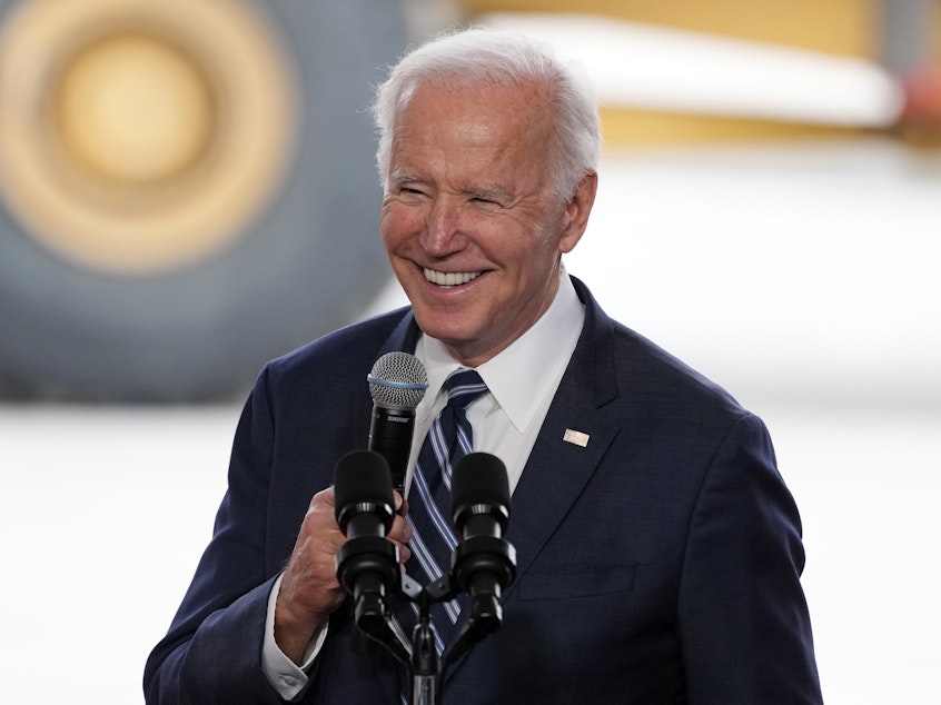 caption: President Biden smiles as he speaks after touring the Taiwan Semiconductor Manufacturing Co. facility under construction in Phoenix on Dec. 6, 2022.