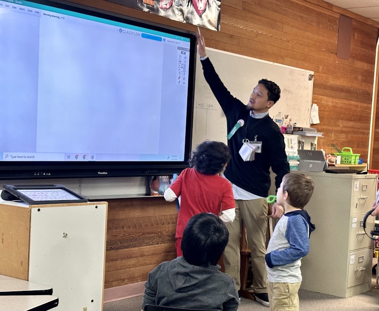 caption: Joshua Wisnubroto leads the morning meeting in his class of kindergartners and first-graders with autism Jan. 19, 2024, at Picnic Point Elementary.