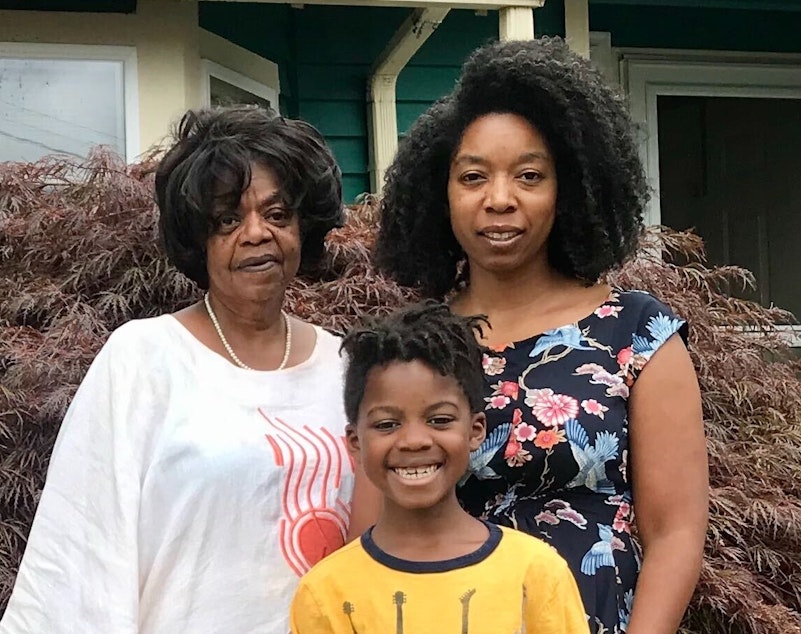 caption: Dawn, Miles and Anisa Mason pose for a portrait at home on July 23rd, 2020.