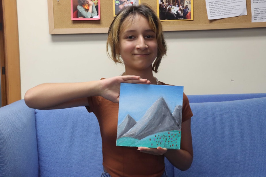 caption: Sabrina painted three snowy mountains at her Ukrainian Refugee Summer Camp.