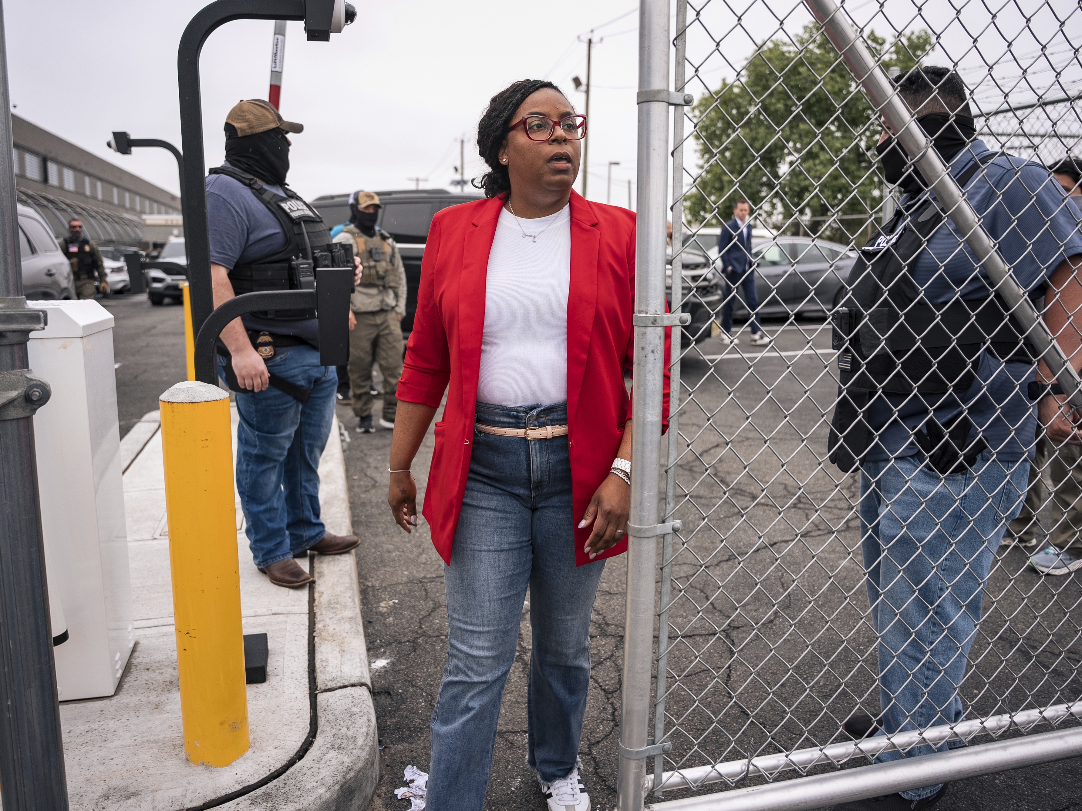 caption: Rep. LaMonica McIver, D-N.J., walks through a security gate at the Delancey Hall immigration detention center in Newark, N.J., on Friday, May 9. The member of Congress now faces federal charges stemming from her visit to the facility that day.
