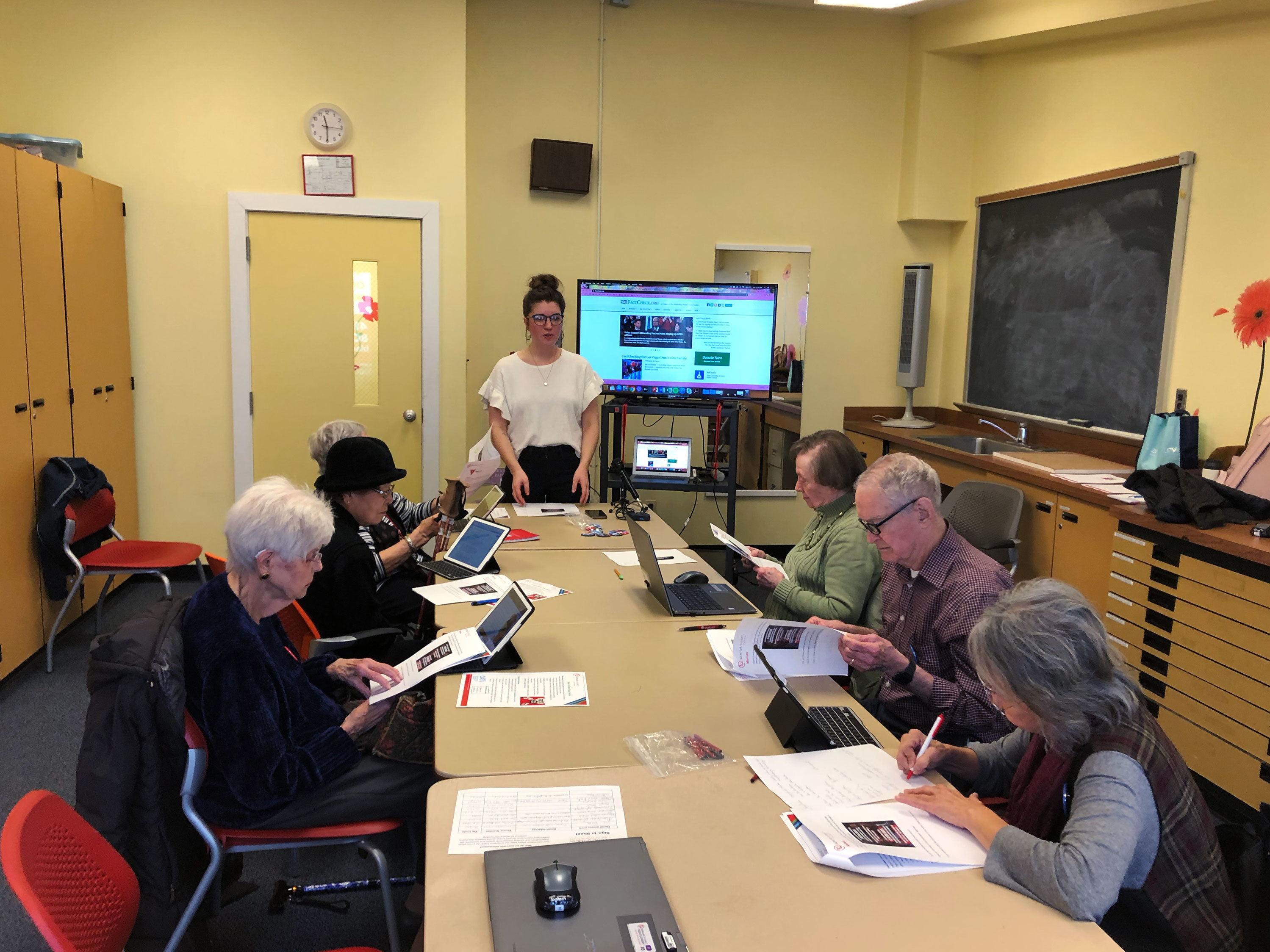 caption: Bre Clark leads a workshop at the Schweinhaut Senior Center in Silver Spring, Md., called How to Spot Fake News.