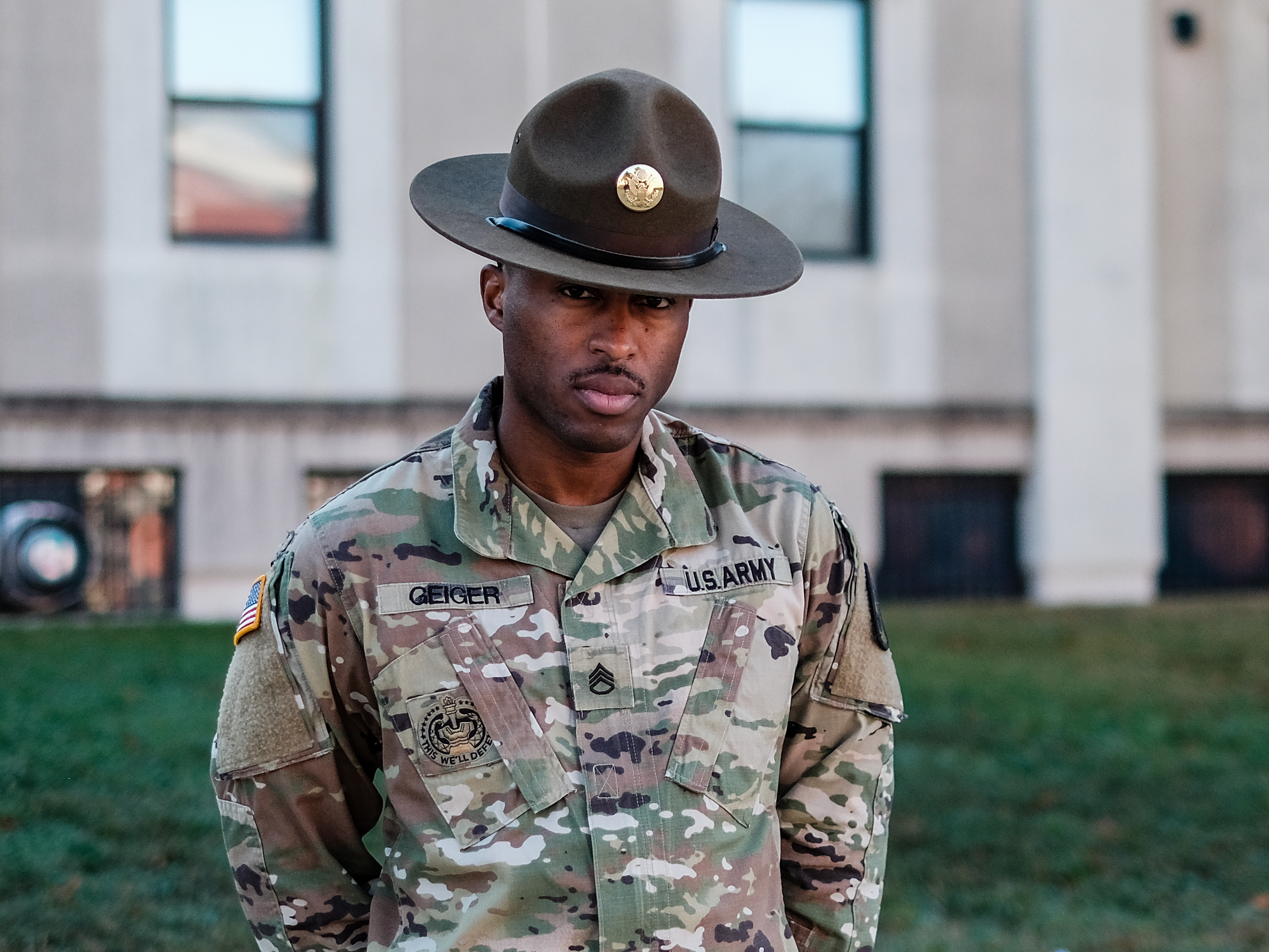 caption: Sr. Drill Sgt. Justin Geiger at Fort Meade. He says of Colin Powell, "It is the responsibility of not only Black service members, but Black families to continue to let Powell's name ring bells throughout our community."