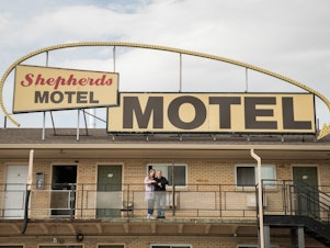 caption: Office manager Shannin Hamilton (left) of the Shepherds Motel in Denver, and Orlando Martinez, co-owner, say that as the coronavirus pandemic begins to cause economic strain in the U.S., the motel's guests have started asking for help paying for rooms.