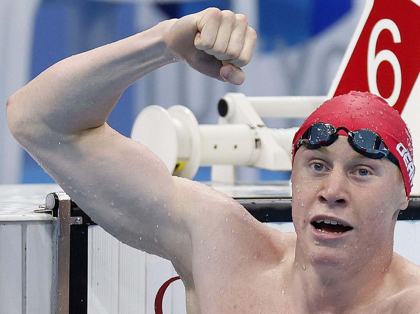 caption: Britain's Tom Dean celebrates winning gold in the men's 200-meter freestyle swimming event at the Tokyo Olympics on Tuesday.