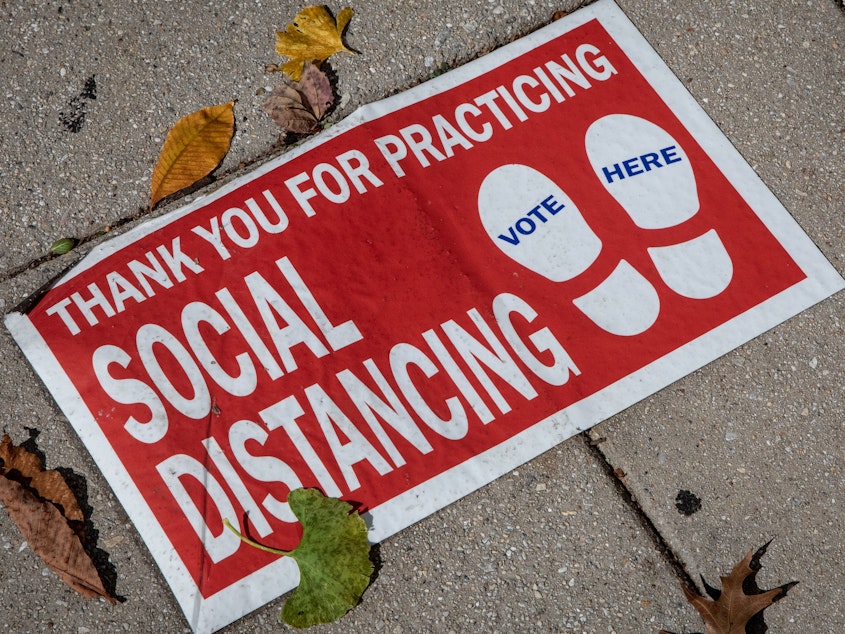 caption: A social distancing sign on the ground. "Social distancing" was one of dozens of terms highlighted by researchers in Oxford Languages' 2020 Word of the Year campaign.