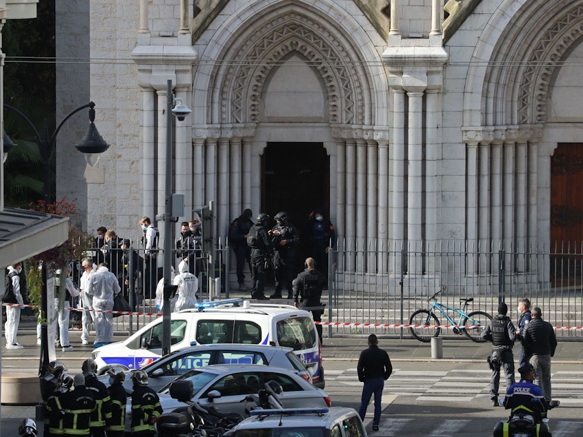 caption: French members of the RAID elite tactical police unit search the Notre Dame Basilica after a knife attack in Nice. A man wielding a knife killed three people and injured several others in Thursday's attack, officials said. The suspected assailant was detained shortly afterwards.