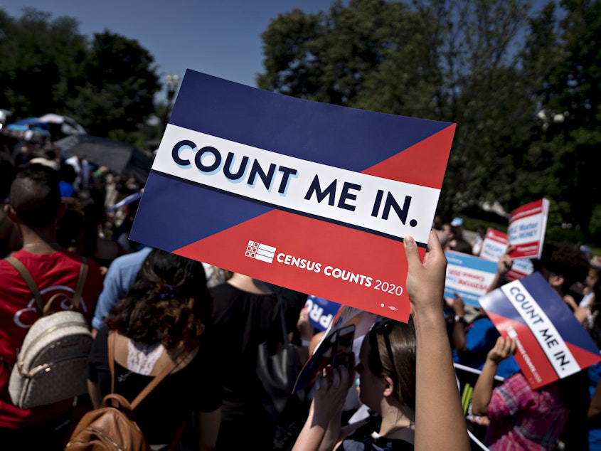 caption: A demonstrator holds a sign that reads "Count Me In" outside the U.S. Supreme Court in 2019. Sen. Brian Schatz, D-Hawaii, has introduced companion legislation to a House bill that could help prevent political interference with future head counts.