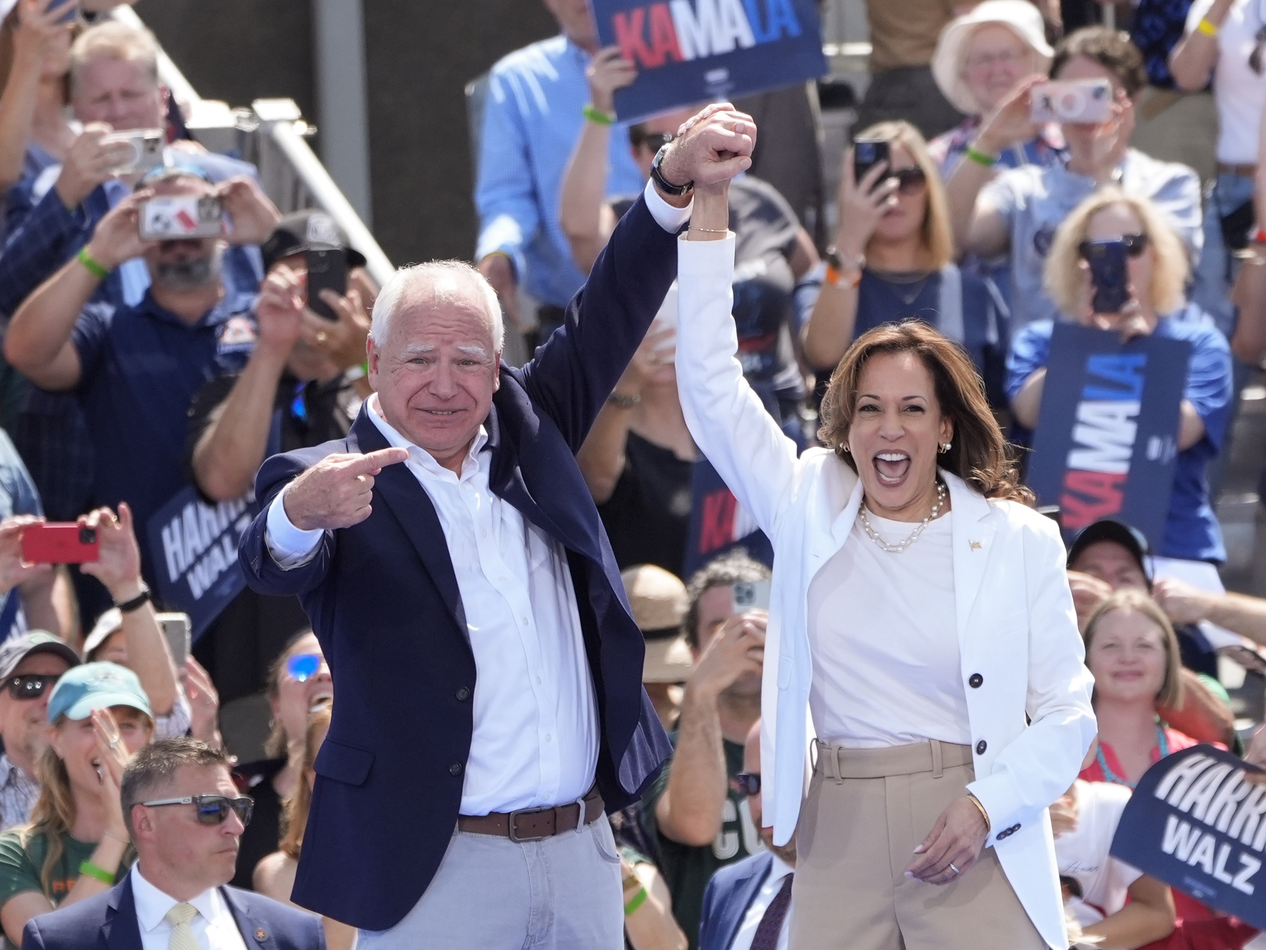 caption: Democratic presidential nominee Vice President Kamala Harris is welcomed by Democratic vice presidential nominee Minnesota Gov. Tim Walz, before she delivers remarks at a campaign event, Wednesday, Aug. 7, 2024, in Eau Claire, Wisc.