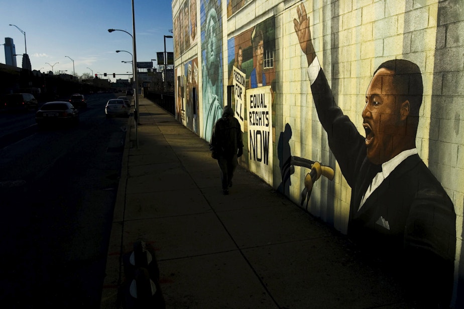 caption: A person walks past a mural of Martin Luther King in Philadelphia, Friday, Jan. 18, 2008. Monday, Jan. 21, 2008 is Martin Luther King Day. (Matt Rourke/AP)