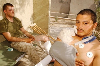 caption: U.S. Marine Corps Lance Cpls. Chris Covington (left) and Carlos Gomez Perez recover from shrapnel and bullet wounds on April 27, 2004, after Iraqi insurgents attacked near Fallujah, Iraq. Just two weeks earlier, Covington and Gomez Perez helped evacuate wounded Marines and soldiers after a deadly explosion rocked a schoolhouse in Fallujah.