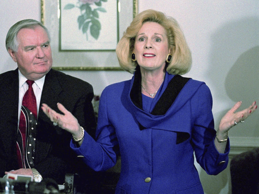caption: In this March 2, 1995 file photo, Word of Faith Fellowship church leader Jane Whaley talks to members of the media, accompanied by her husband, Sam, in Spindale, N.C.