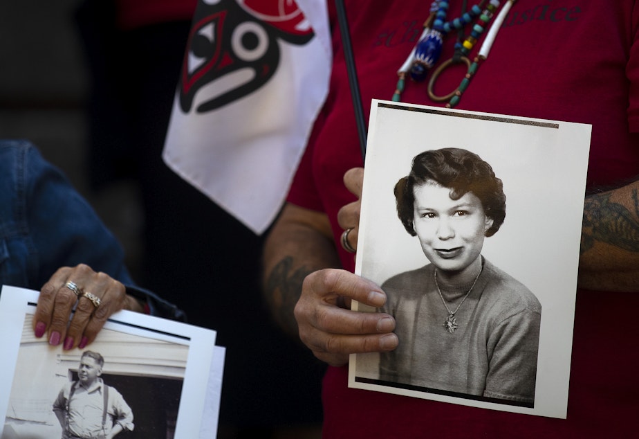 caption: Vice Chairman of the Chinook Indian Nation Sam Robinson holds photographs of his relatives, including aunt Lois Gardner, while gathered on the steps of the Henry M. Jackson Federal building during a rally for the restoration of federal recognition for the Chinook Indian Nation, on Monday, August 29, 2022, in Seattle. 