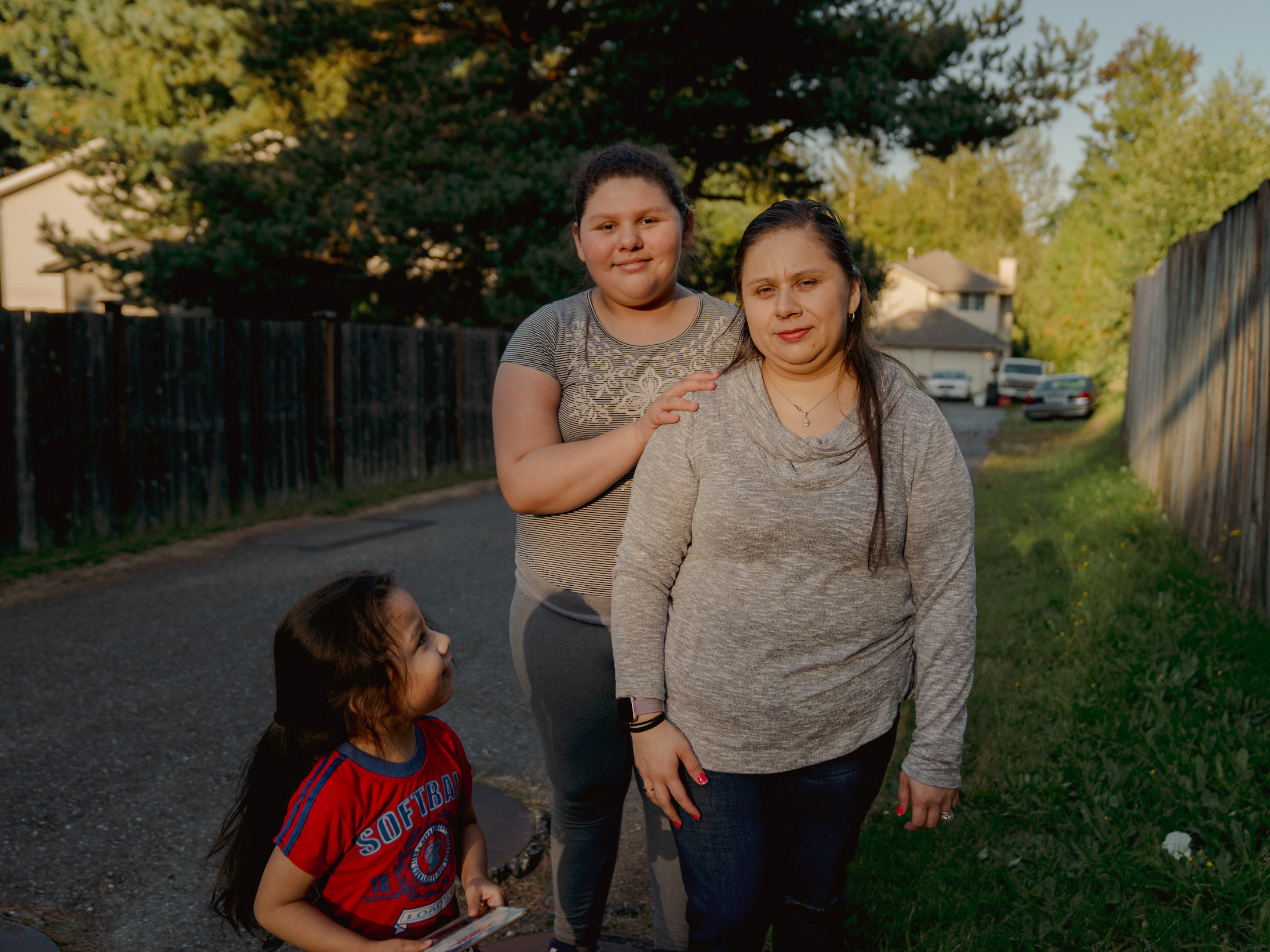 caption: Patricia Lopez, right, with her daughter, Yamely Alfaro Lopez, 11, and son, Kevin Alfaro Lopez, 3, in Everett, Wash.