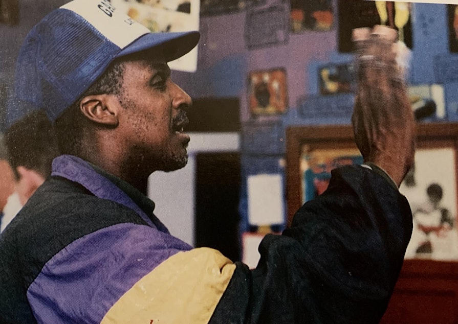 caption: Wendell "Rick" Hicks waves goodbye to the class of 1998 in this yearbook photo from the Garfield High School Arrow.