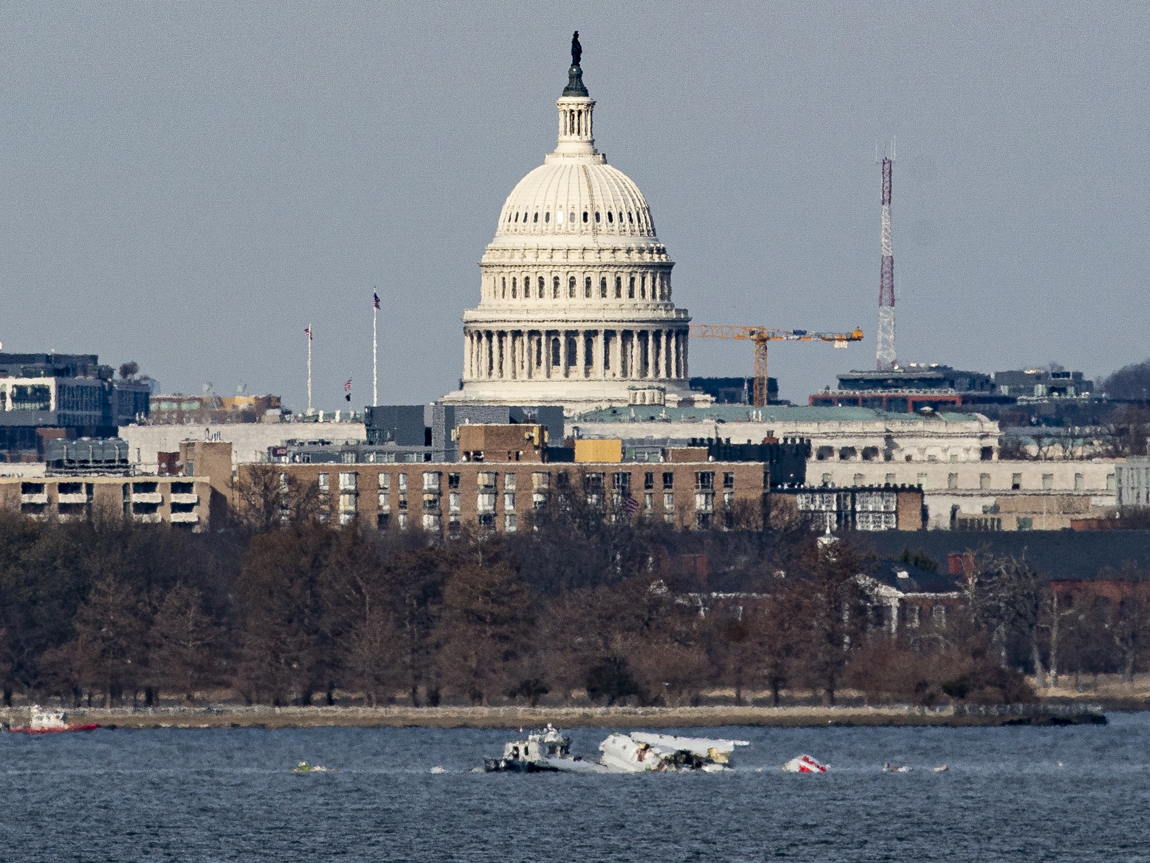 caption: Emergency response units work at the site of the American Airlines plane that crashed into the Potomac River on Wednesday on approach to Reagan National Airport.