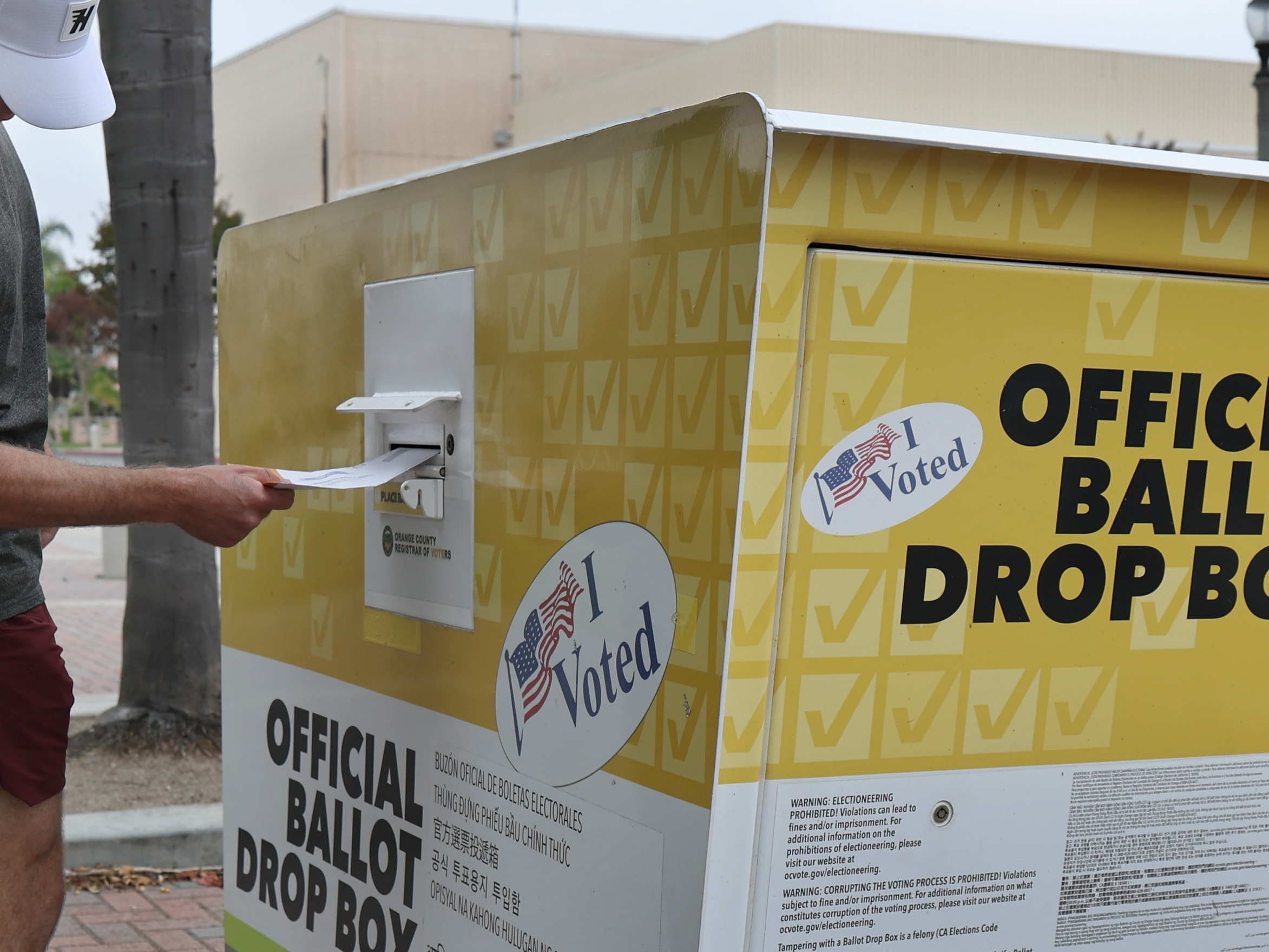 caption: Garrett Morgan, of Huntington Beach, Calif., puts his statewide special election ballot in an official ballot drop box in Huntington Beach on Oct. 25.