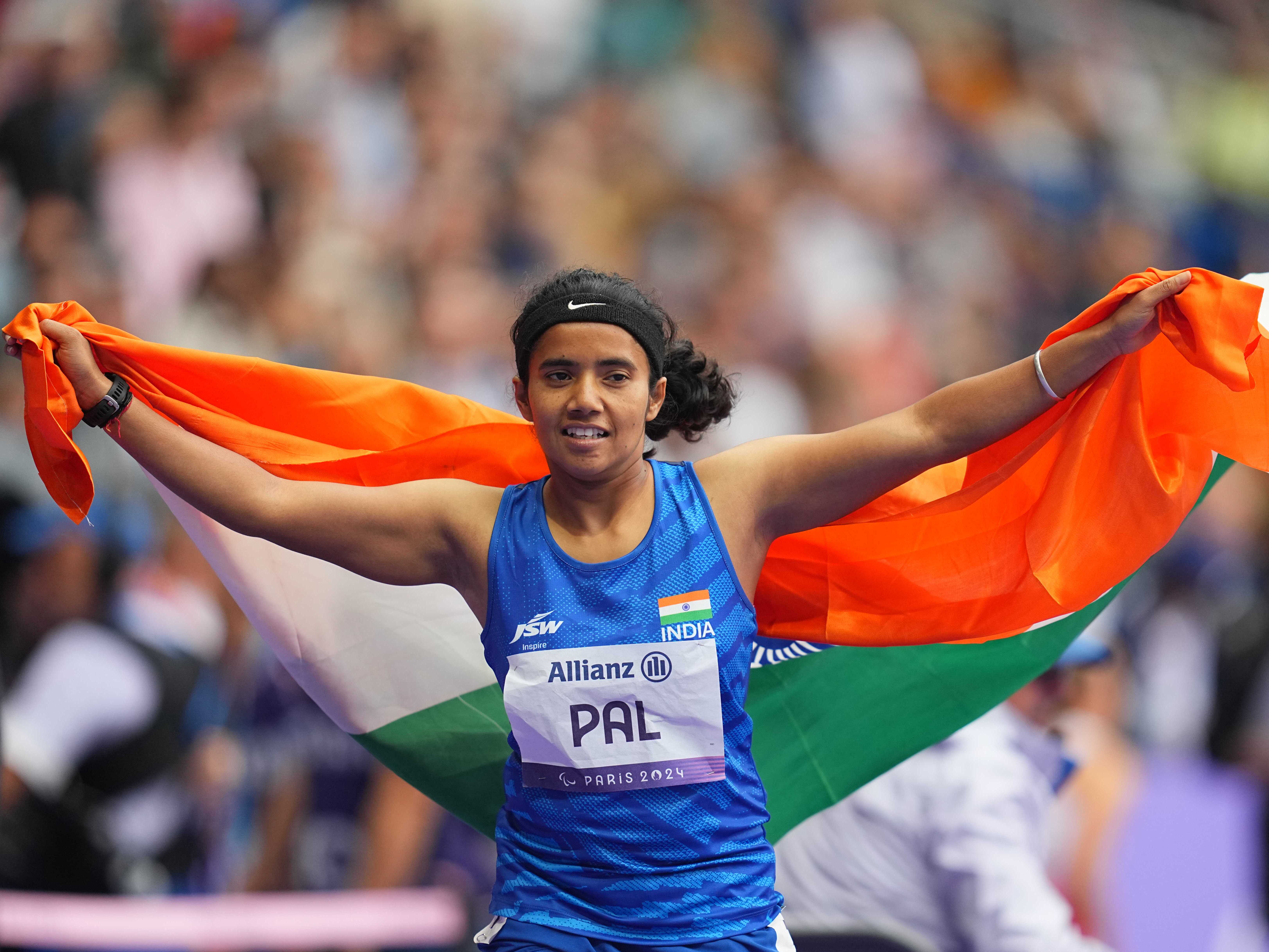 caption: Preeti Pal of India celebrates winning a bronze medal in the Women's 100m - T35 Final during the Paris 2024 Paralympic Games on August 30. She won a second bronze in the 200m final two days later -- and became an instant hero in her homeland. 