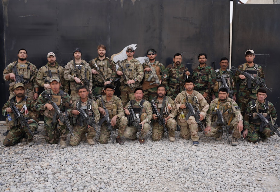 caption: Team 11 was a group working with the U.S. Army Special Forces to clear IEDs in Afghanistan operations.