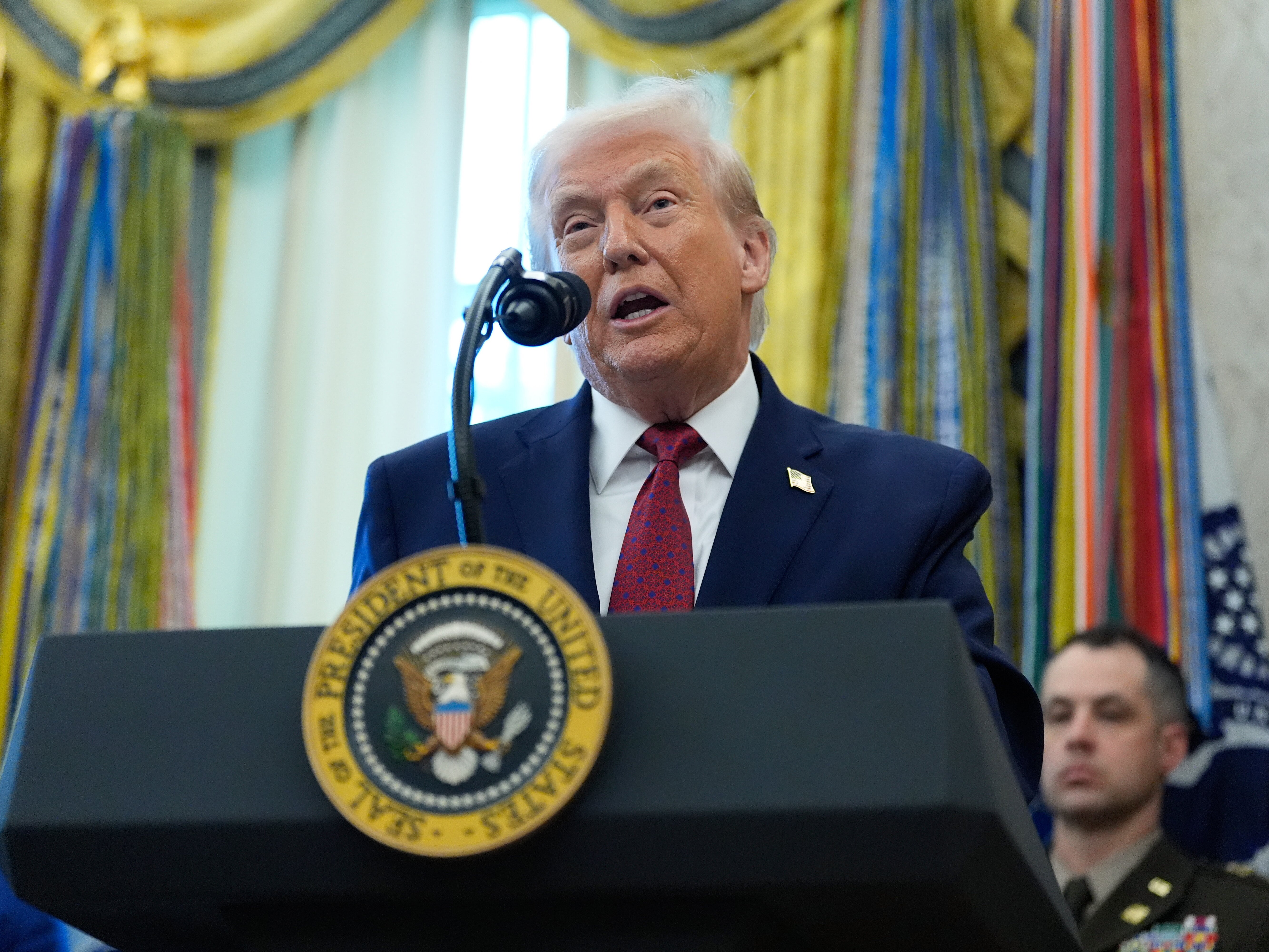 caption: President Donald Trump speaks during a Mexican Border Defense Medal presentation in the Oval Office of the White House, Monday, Dec. 15, 2025, in Washington.