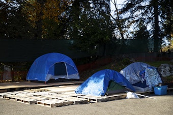 caption: Tents are set up outside of the Oasis Home Church on Thursday, Nov. 16, 2023, in Burien, Washington. 