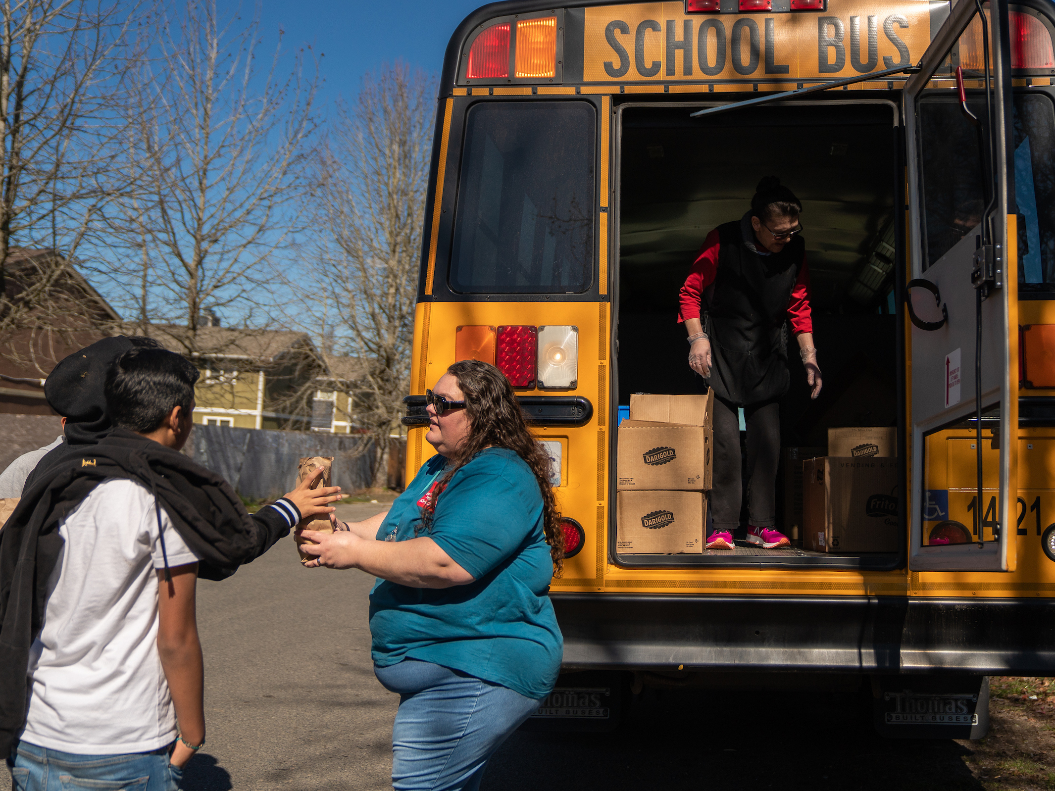 caption: Franklin Pierce Schools bus driver Margie Huggler hands out free meals to students in Tacoma, Wash.