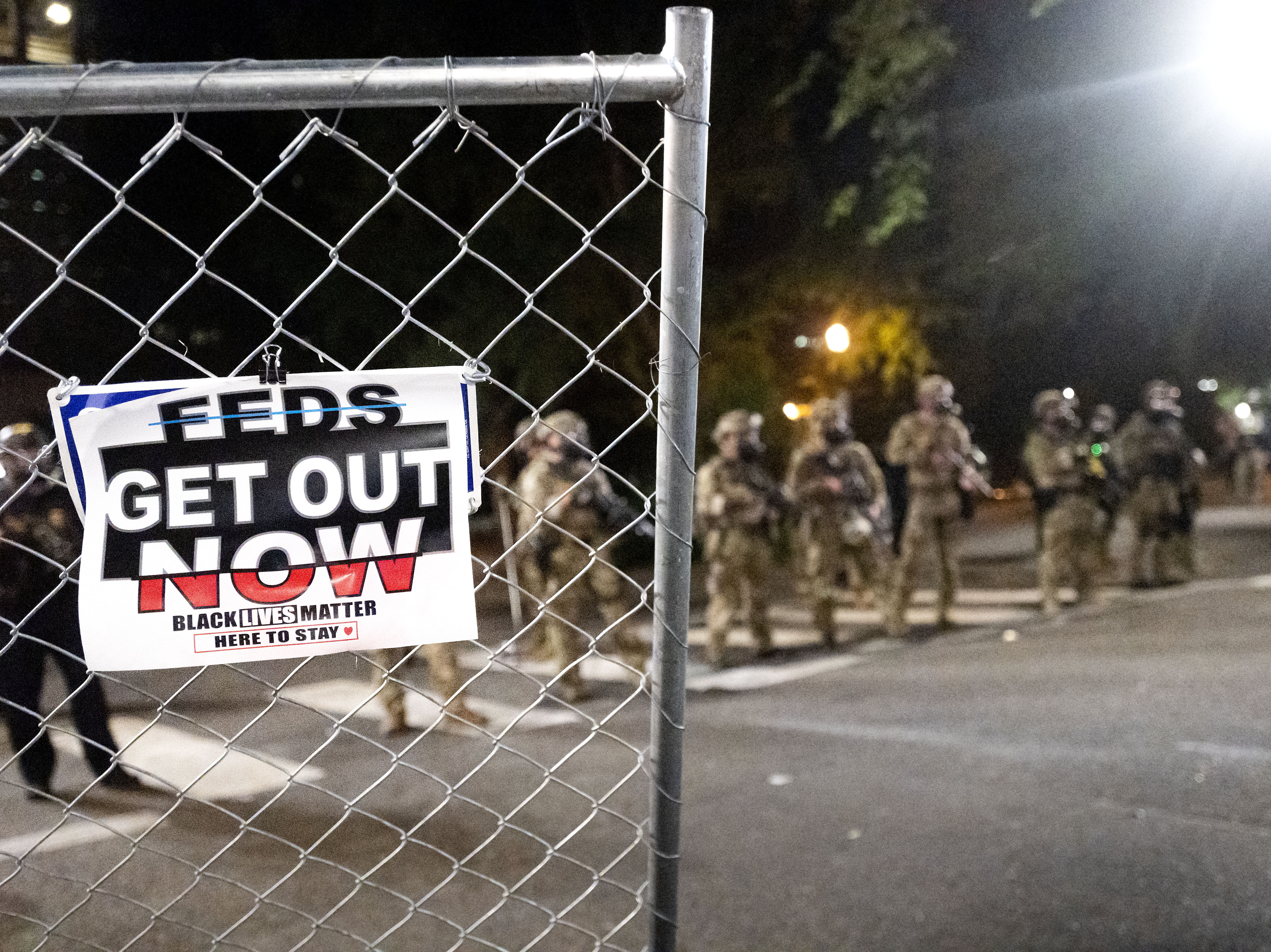 caption: Federal agents dispersed protesters near the Mark O. Hatfield United States Courthouse on Monday in Portland, Ore. State and local officials say the federal law enforcement officers have incited violence in the city.