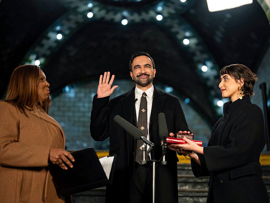caption: Zohran Mamdani is sworn in as New York City's 112th mayor by New York Attorney General Letitia James, left, alongside his wife Rama Duwaji, right, in the former City Hall subway station on January 1, 2026 in New York City.