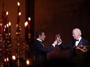 caption: President Biden and French President Emmanuel Macron toast during a state dinner on the South Lawn of the White House in Washington, D.C., on Thursday.