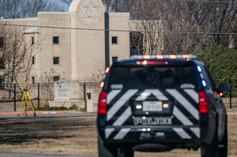 caption: A police vehicle sits near the Congregation Beth Israel synagogue in Colleyville, Texas, on Jan. 16, 2022. Four people were held hostage at the synagogue for more than 10 hours by a gunman before being freed, one of a spate of antisemitic acts that took place last year.