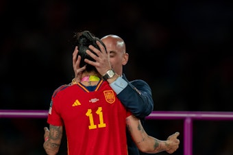caption: Royal Spanish Football Federation President Luis Rubiales is being criticized for kissing Spanish player Jennifer Hermoso on the mouth during the medal ceremony following Spain's victory in the final of the Women's World Cup on Sunday in Sydney.