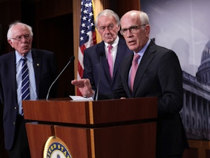 caption: Democratic Sen. Peter Welch of Vermont, flanked by Sens. Bernie Sanders of Vermont and Ed Markey of Massachusetts, addressed concerns about debt limit negotiations during a press conference on Thursday. A group of Senate Democrats sent a letter to President Biden urging him to invoke the 14th Amendment to avoid a debt default if he can't reach a deal with Republicans.