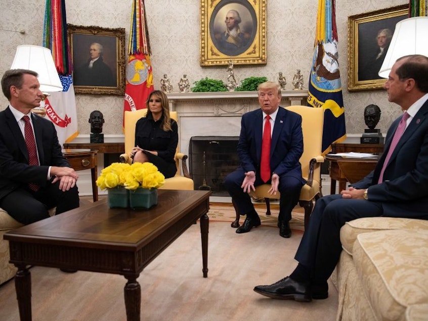 caption: President Trump speaks to the press with First Lady Melania Trump and Health and Human Services Secretary Alex Azar (right) and acting Commissioner of the Food and Drug Administration Norman Sharpless (left) in the Oval Office at the White House Wednesday to announce a proposed ban on flavored vaping products.