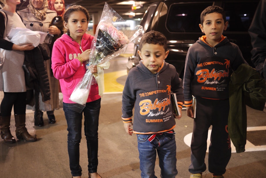 caption: Syrian refugees arrive at Sea-Tac Airport in November, 2015