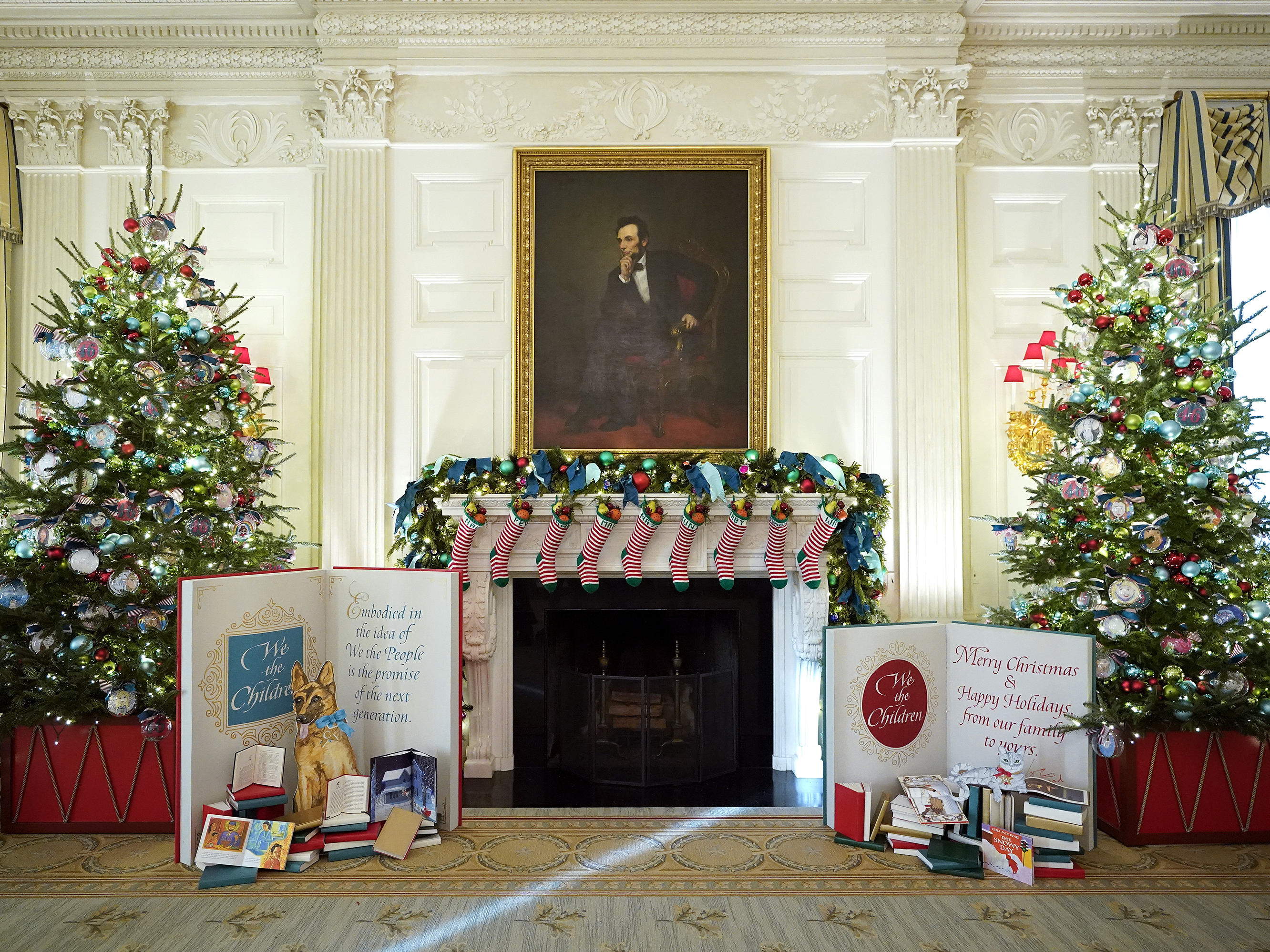 caption: The State Dining Room of the White House is decorated for the holiday season with stockings for family members of President Biden and First Lady Jill Biden.