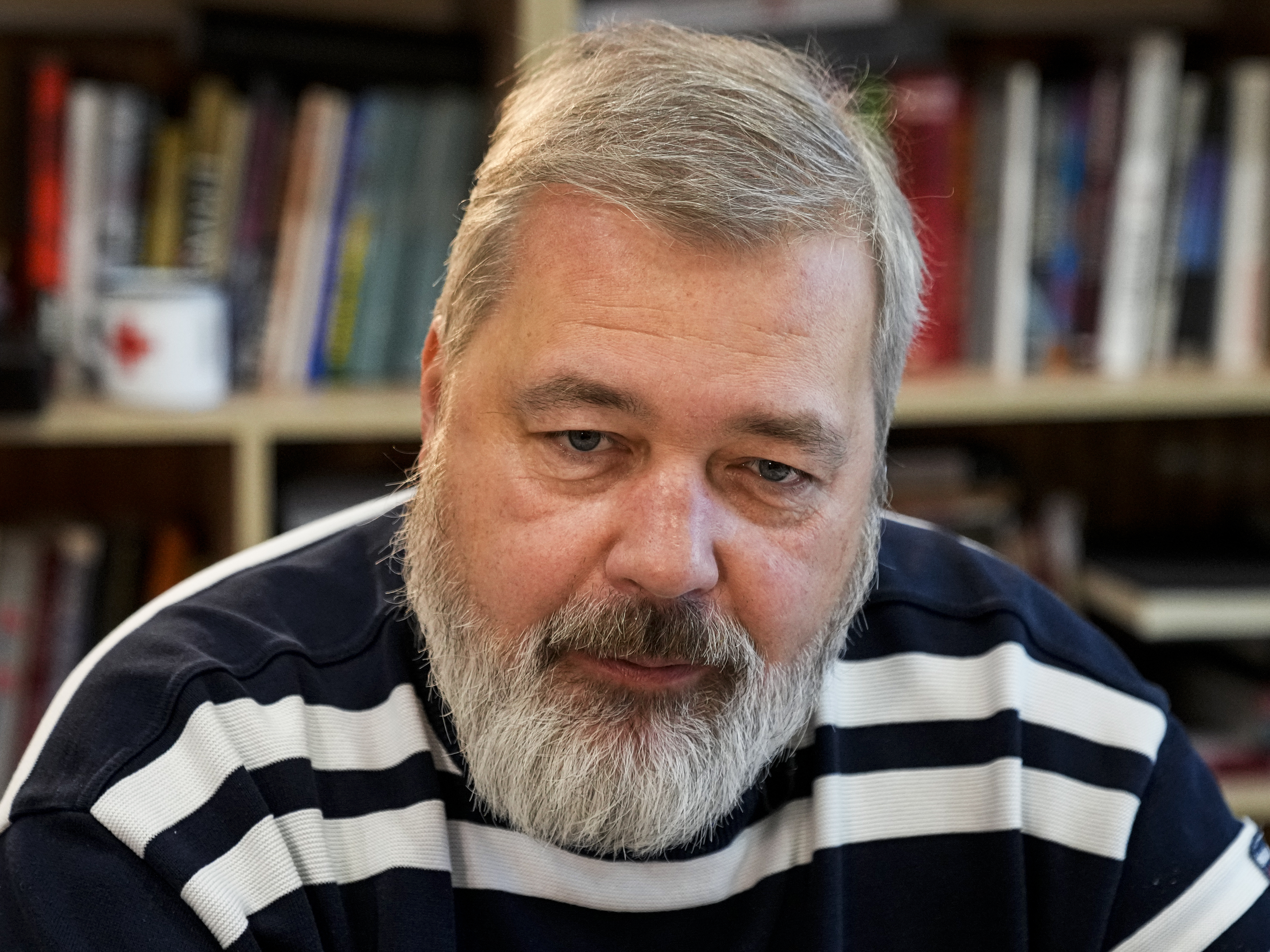caption: In this Oct. 7, 2021 file photo, Novaya Gazeta editor Dmitry Muratov speaks during an interview with The Associated Press at the Novaya Gazeta newspaper, in Moscow, Russia.