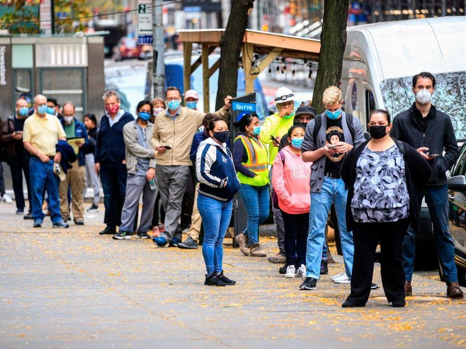 caption: With new infections rising across the country, states are struggling to slow the spread, and testing can barely keep up. Here, people line up outside a coronavirus testing site this month in New York.