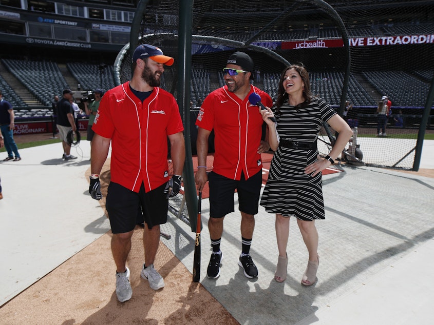 caption: Colorado Rockies television announcer Jenny Cavnar, right, jokes with Vinny Castilla, center, special assistant to the Rockies general manager, and Denver Broncos fullback Andy Janovich after they took part in the UC Healthy Swings Charity Home Run Derby Tuesday, June 11, 2019, in Coors Field in Denver.