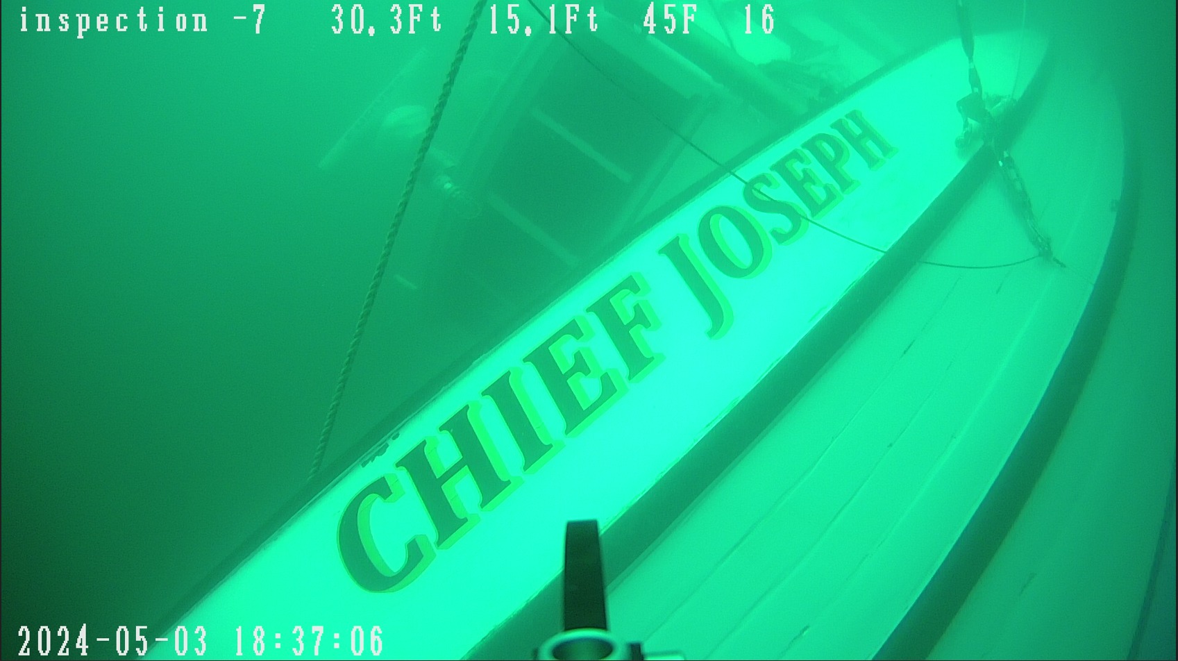 caption: The fishing vessel Chief Joseph lies on its side after sinking off Washington's Henry and San Juan islands on May 3, 2024.