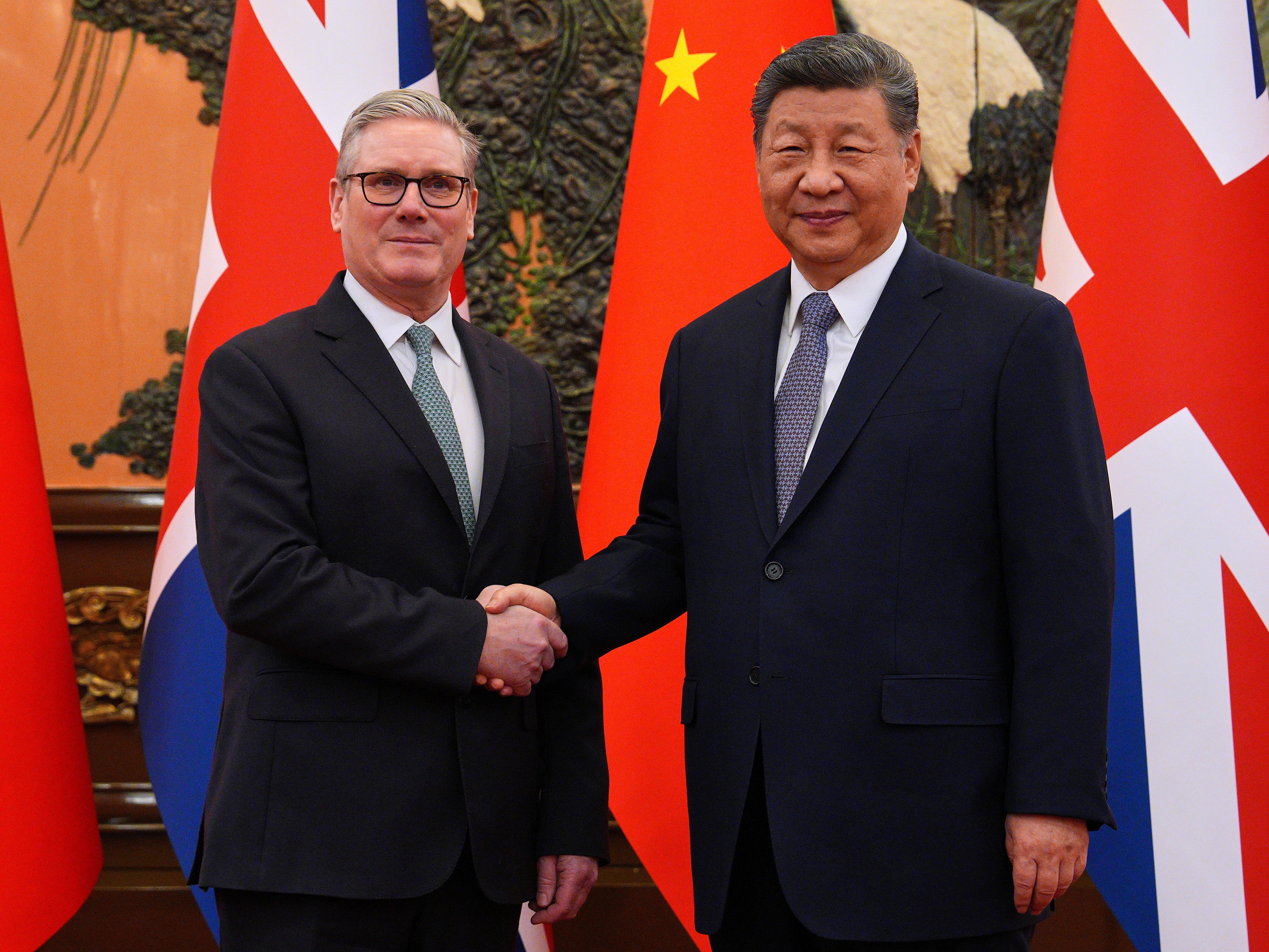 caption: Britain's Prime Minister Keir Starmer, left, shakes hands with Chinese President Xi Jinping ahead of a bilateral meeting in Beijing, China, Thursday, Jan.29, 2026.