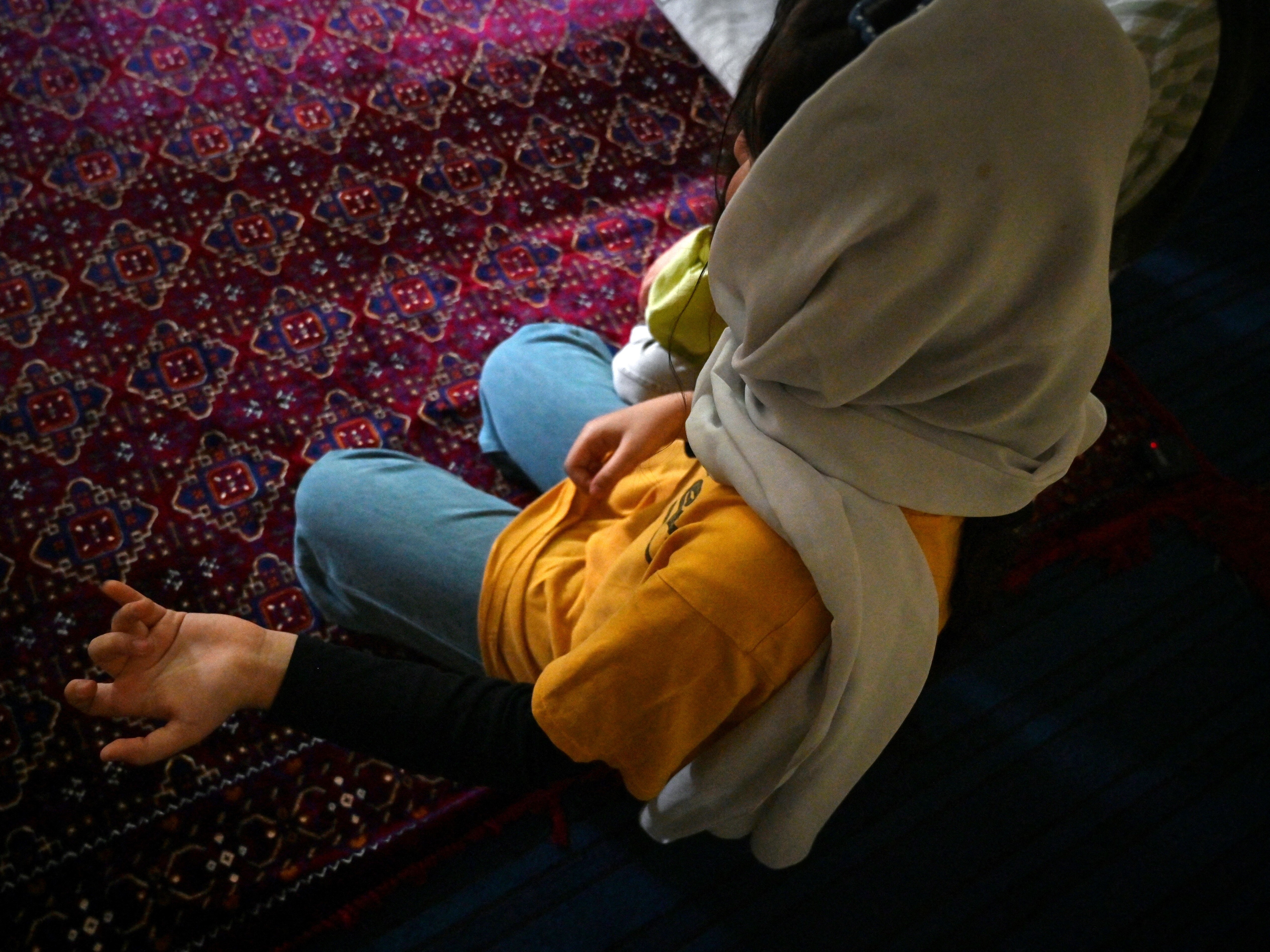 caption: Afghan refugee girl Laylama is pictured during a September 2025 interview with AFP in Islamabad, where she was living after President Trump suspended refugee admissions to the U.S.