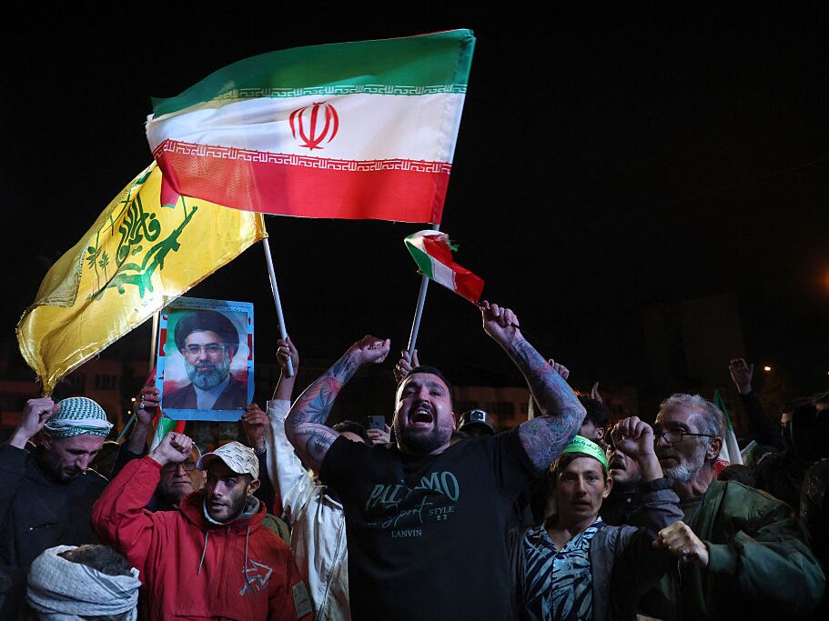 caption: Iranians react after a ceasefire announcement at the Enqelab square, in Tehran, on Wednesday.
