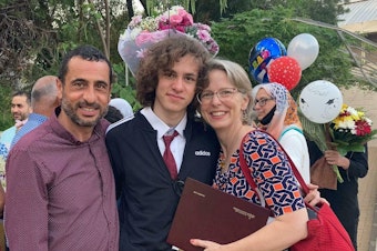 caption: Hisham Awartani with his father, Marwan Awartani, and mother, Elizabeth Price. On Saturday, Awartani was one of three men of Palestinian descent shot in Burlington, Vermont.
