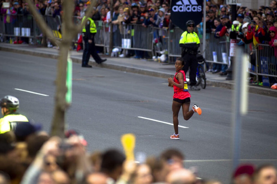 caption: Buzunesh Deba, of Ethiopia, looks over her shoulder on the home stretch of Boylston Street as she came in for a second-place finish in the women's race of the 118th Boston Marathon on Monday, April 21, 2014. (Dina Rudick/The Boston Globe via Getty Images)