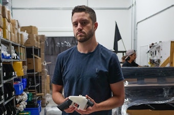 caption: Cody Wilson, owner of Defense Distributed, holds a 3D printed gun, called the "Liberator," in his factory in Austin, Texas, in August. The 30-year-old has been accused of sexually assaulting a minor.