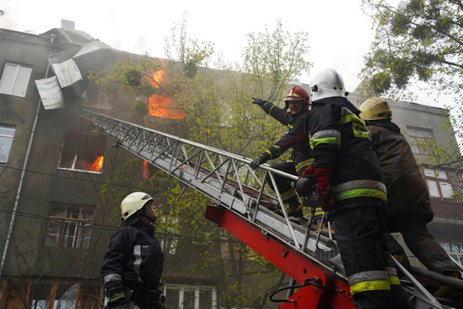 caption: Firefighters work to extinguish fire at an apartments building after a Russian attack in Kharkiv, Ukraine, Sunday, April 17, 2022. 