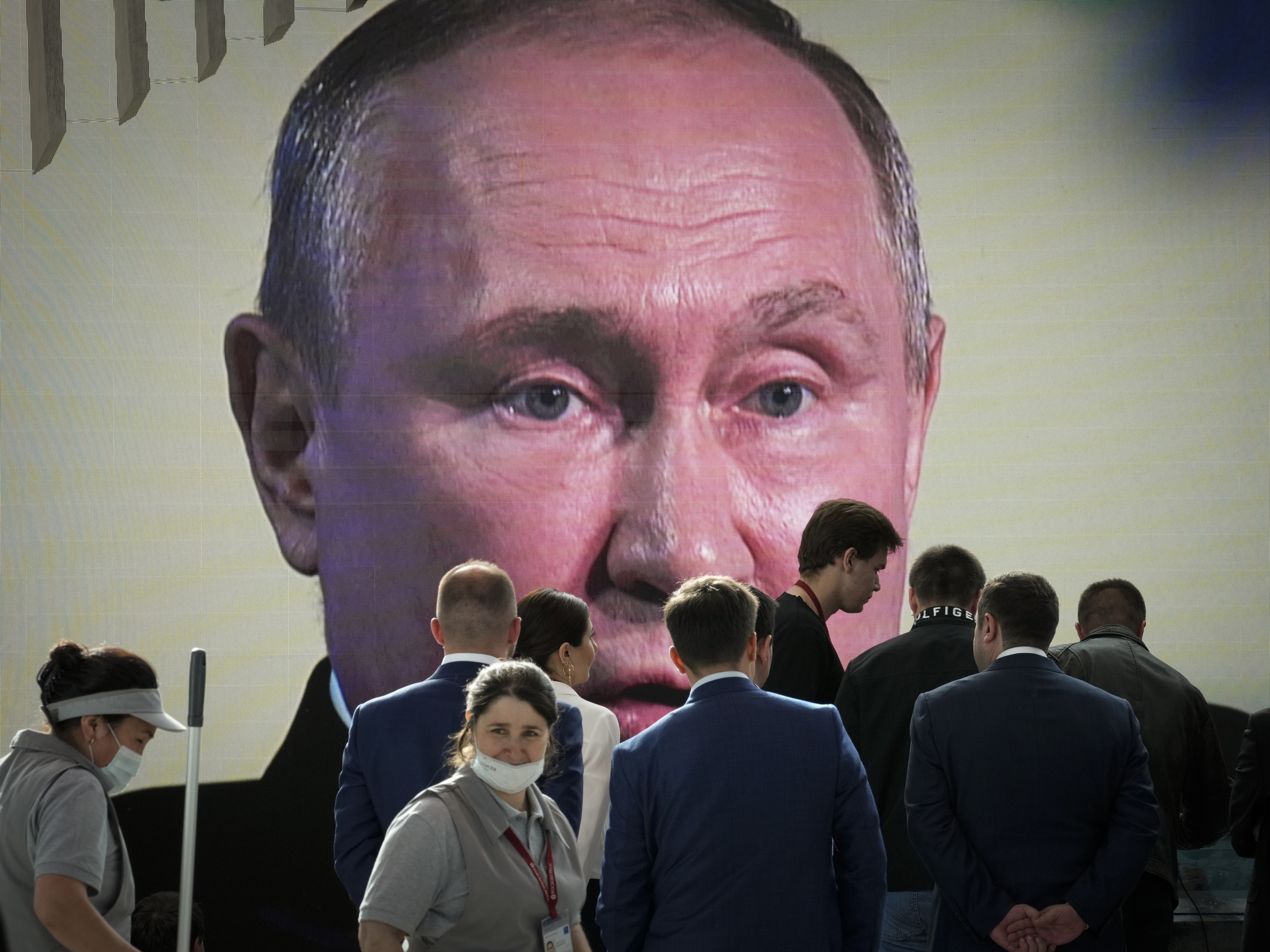caption: Participants watch Russian President Vladimir Putin address the St. Petersburg International Economic Forum in St. Petersburg, Russia, on Friday.