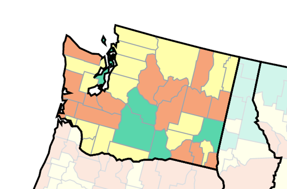 caption: Covid cases in Washington state as of July 5, 2022. Orange means high levels of cases, yellow is medium.